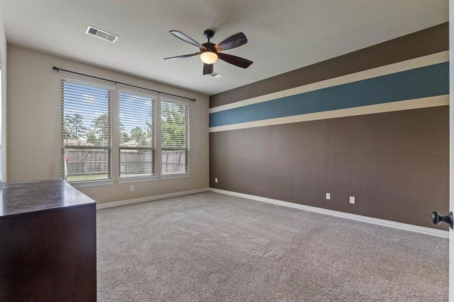 The primary bedroom has a view of the backyard. | Image 19