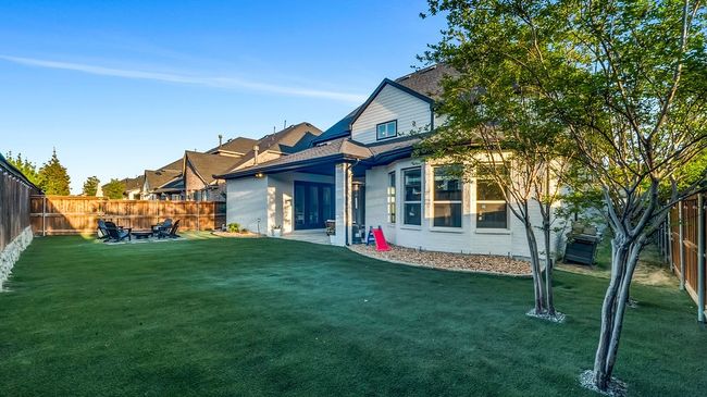 Rear view of property with a turf yard, a patio, and a fenced backyard | Image 24