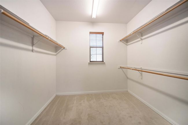 Walk in closet featuring light carpet | Image 24