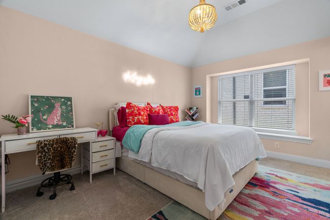 Carpeted bedroom with lofted ceiling, a chandelier, and baseboards | Image 34