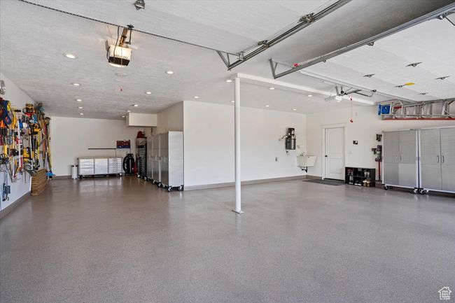 Garage featuring recessed lighting, baseboards, and a garage door opener | Image 48