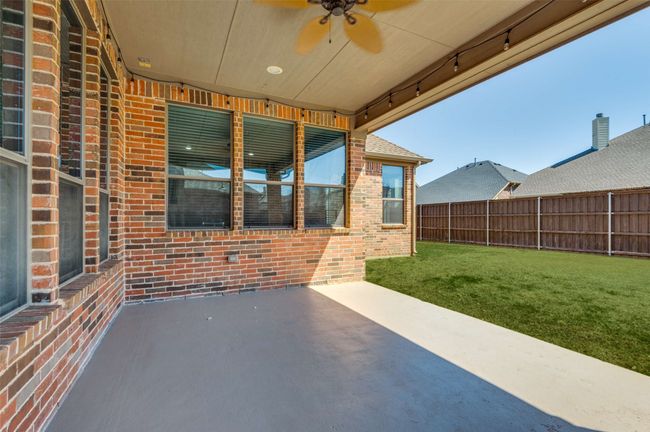 View of patio / terrace with a ceiling fan and fence | Image 36