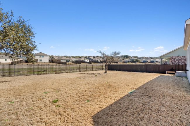 View of yard featuring a fenced backyard and a residential view | Image 30