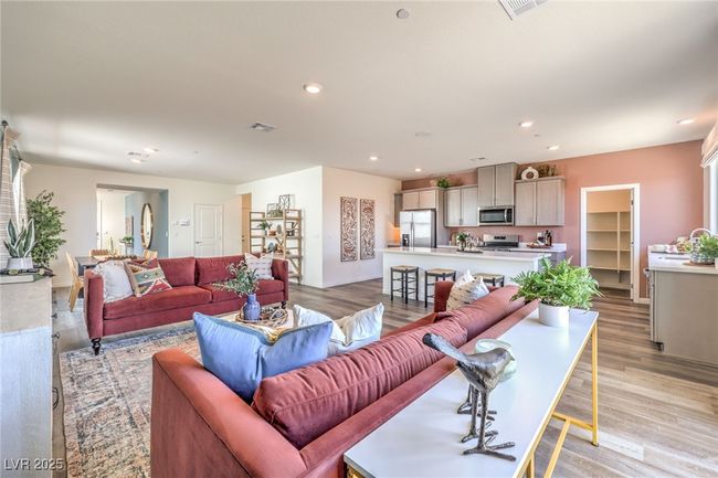 Living room with light wood-style flooring and recessed lighting. Photo is representational only; actual home finishes may vary. | Image 12