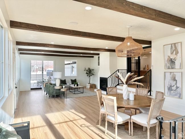 Dining space featuring beamed ceiling, light wood-style floors, stairway, and recessed lighting | Image 17