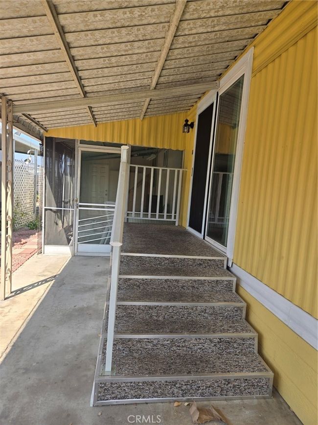 Carpeted stairs to entry | Image 17