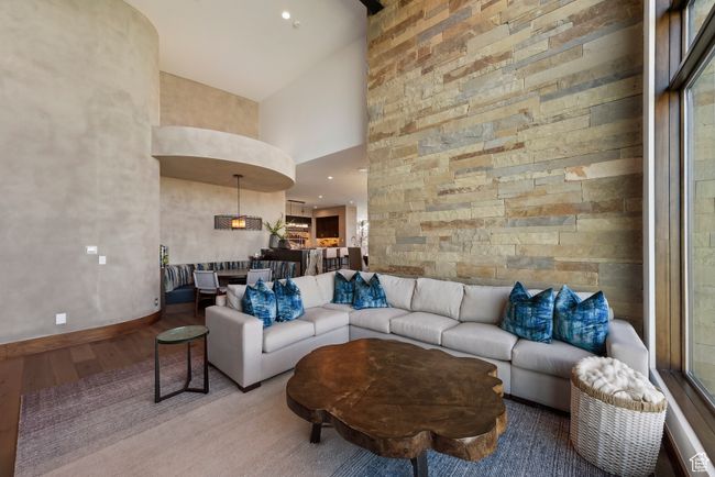 Living room with high vaulted ceiling, wood finished floors, and baseboards | Image 17