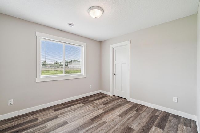 Second bedroom featuring a walk-in closet. | Image 17