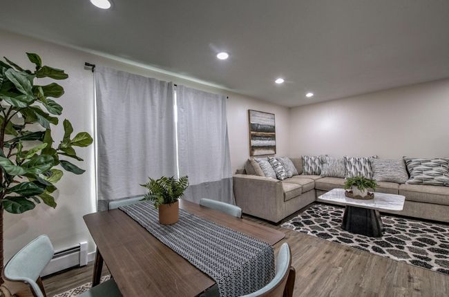 Living room featuring a baseboard heating unit, recessed lighting, and wood finished floors | Image 11