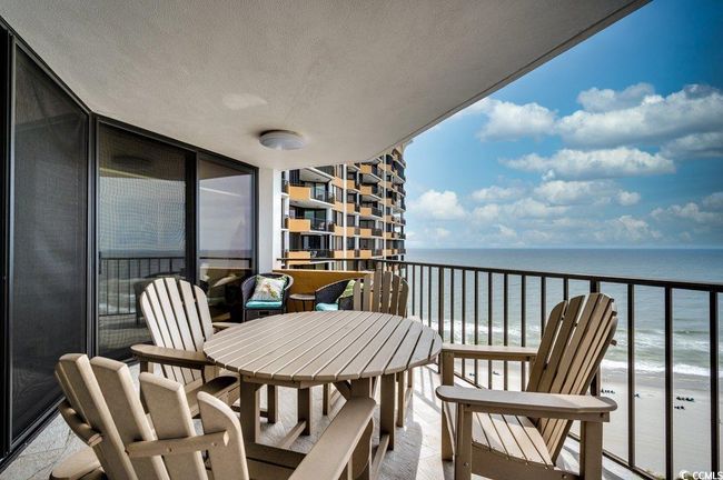 Balcony featuring a water view and a view of the beach | Image 22