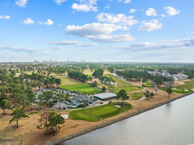 Aerial view of a nearby body of water, a local golf course, and city skyline | Image 30