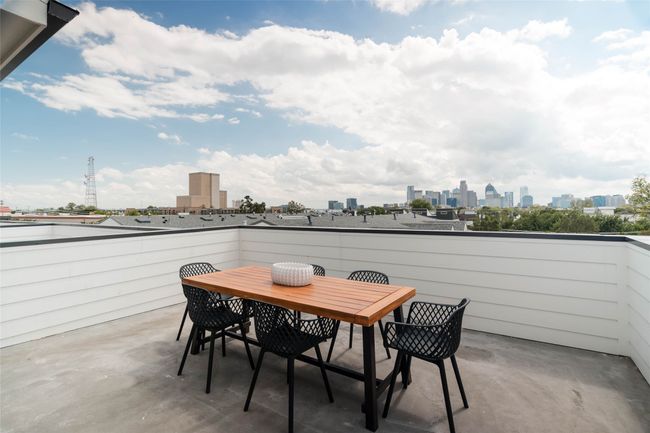 View of patio with outdoor dining space and a city view | Image 28