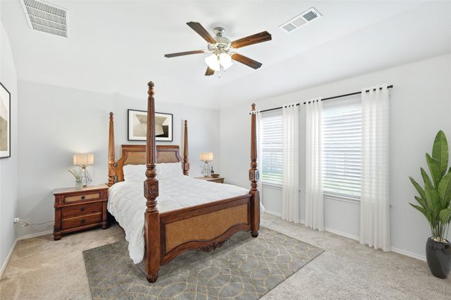 Bedroom featuring carpet, visible vents, and baseboards | Image 28