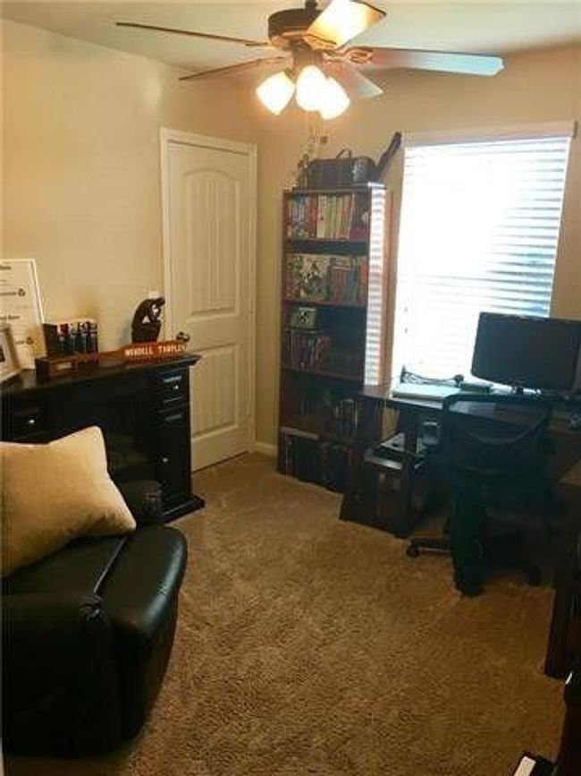 Home office featuring ceiling fan and carpet flooring | Image 9