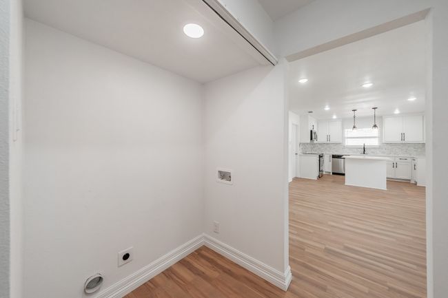 Laundry area with hookup for an electric dryer, light wood-style flooring, hookup for a washing machine, recessed lighting, and baseboards | Image 6