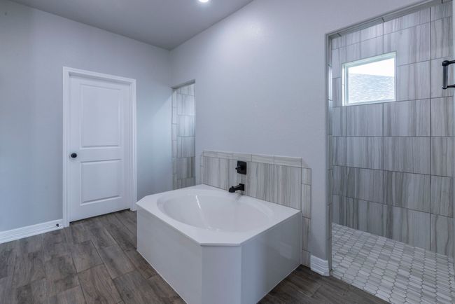 Full bath with a walk in shower, a bath, and wood finished floors | Image 15