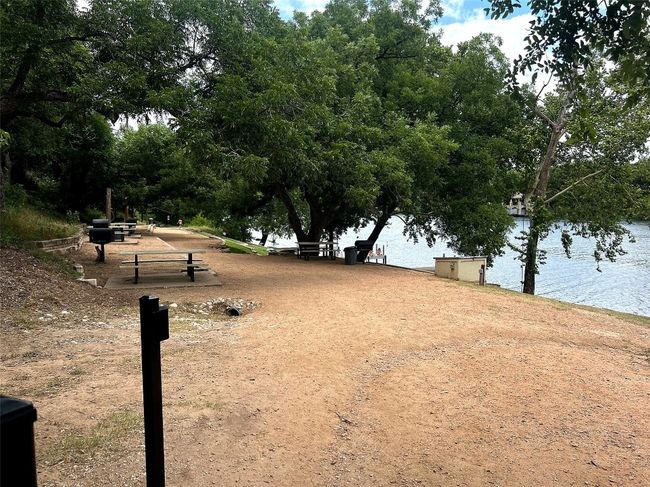 View of picnic benches, Lake Austin, and the residential docks for Apache Shores | Image 10