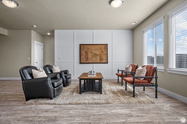 Living area featuring baseboards and wood finished floors | Image 7
