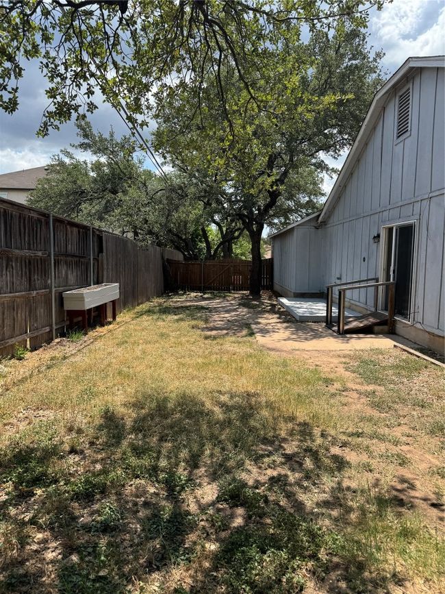 View of fenced backyard | Image 15