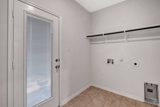 Laundry room with gas dryer hookup, electric dryer hookup, washer hookup, and light tile patterned flooring | Image 19