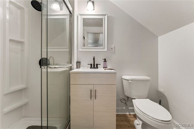 Full bath with toilet, a shower stall, baseboards, vanity, and vaulted ceiling | Image 22