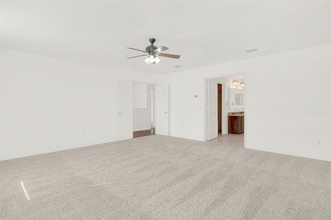 Unfurnished room with light colored carpet, ceiling fan, and baseboards | Image 25