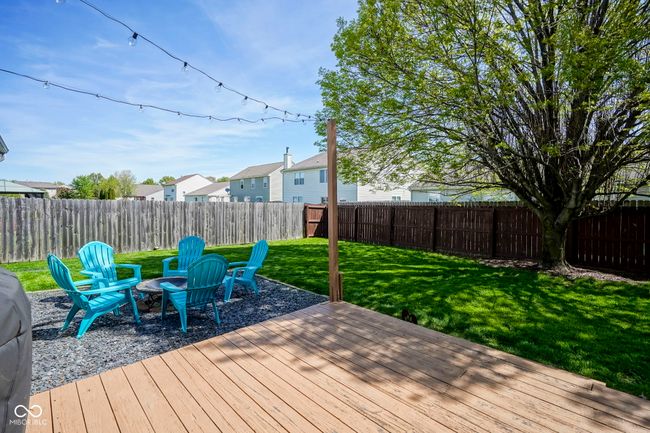 wooden deck with a lawn, a residential view, and a fenced backyard | Image 32