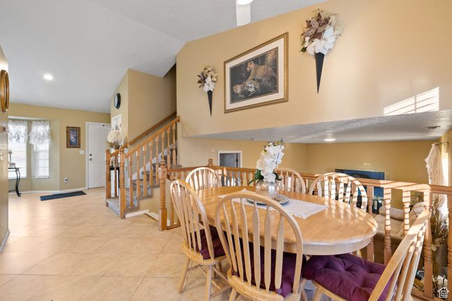 Tiled dining space with vaulted ceiling | Image 15