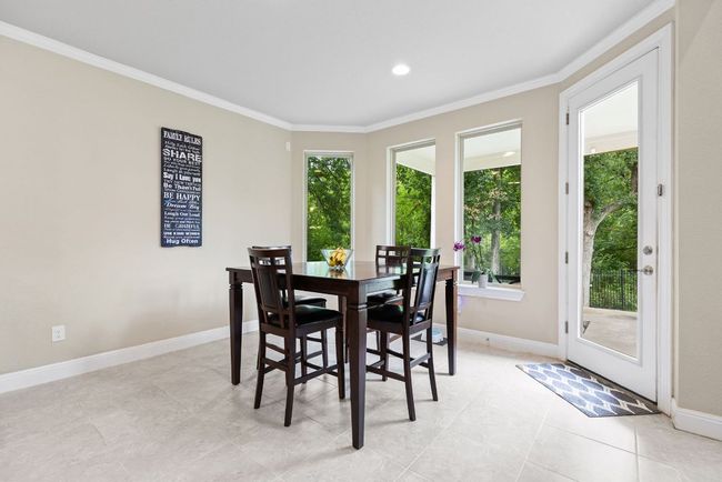 Dining room featuring crown molding, baseboards, light tile patterned floors, and recessed lighting | Image 12
