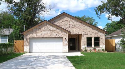 Front view of home and double wide driveway. | Image 1