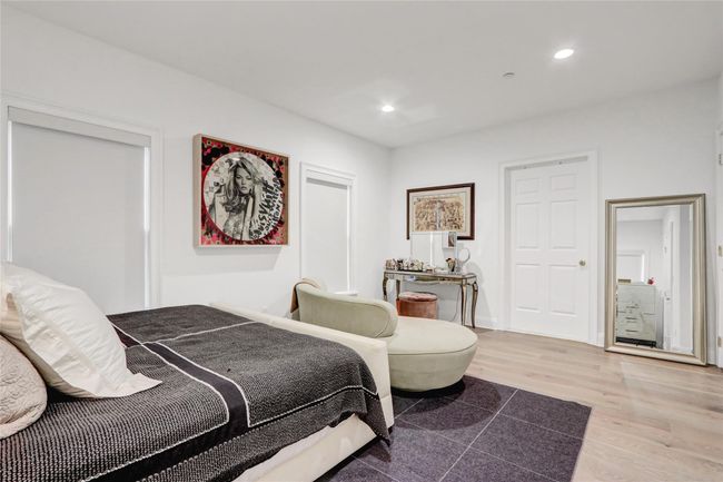 Bedroom with wood finished floors, recessed lighting, and baseboards | Image 14