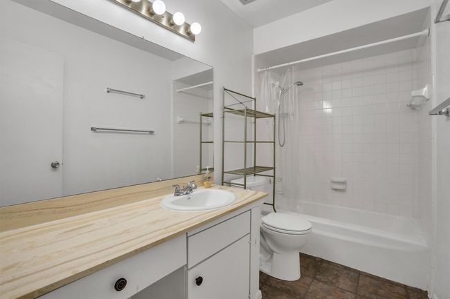 Full bathroom featuring vanity, shower / bath combo, and stone finish floors | Image 21