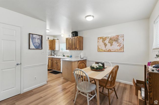 Dining space with light wood finished floors and baseboards | Image 6