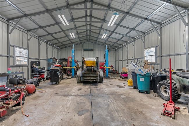 Interior of shop with concrete floors & car lift | Image 33