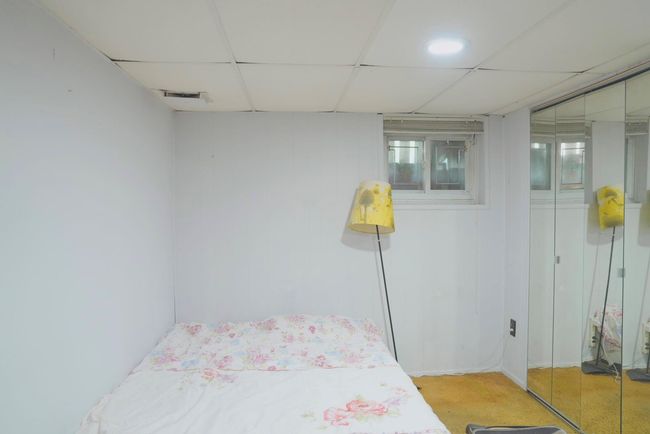 Bedroom with a drop ceiling and light colored carpet | Image 15