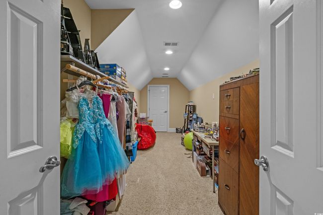 Walk in closet with carpet floors and lofted ceiling | Image 37