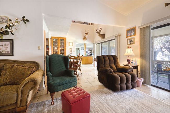 Living room that leads to a dining area and the kitchen. | Image 20