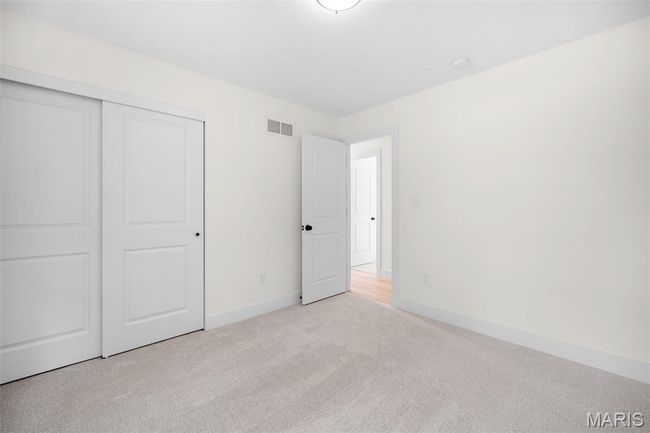 Unfurnished bedroom with carpet flooring and a closet | Image 31