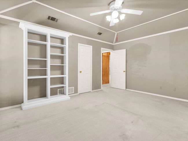 Alternate view of primary bedroom showing storage closet and access to hallway. | Image 25