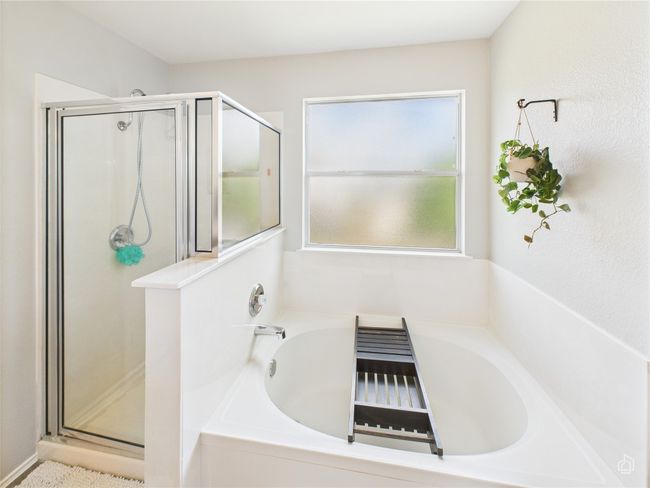 Bathroom featuring a shower stall and a garden tub | Image 15