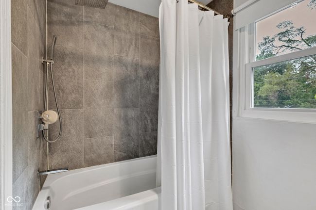Upper floor second bathroom with shower / bath combination with curtain. | Image 41