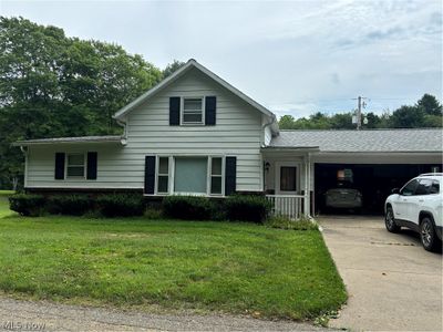 View of front of property featuring a garage and a front yard | Image 1