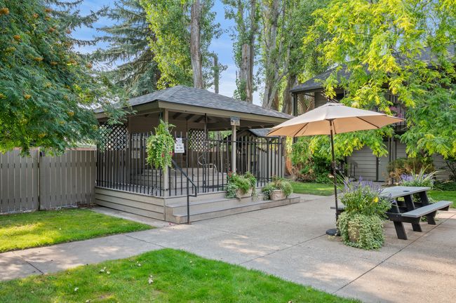 Courtyard with hot tub, ice maker, BBQ, and picnic table | Image 7