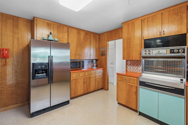 Kitchen with light floors, decorative backsplash, stainless steel appliances, and wood cabinets | Image 18