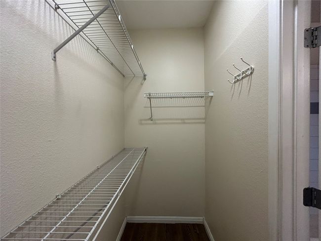 Spacious closet with wood finished floors | Image 11