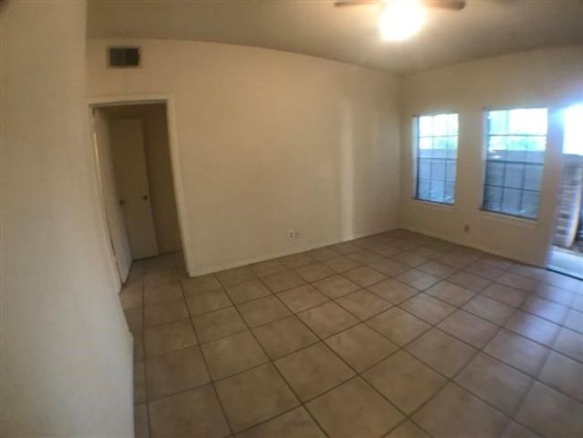 Spare room with visible vents, light tile patterned floors, and a ceiling fan | Image 4