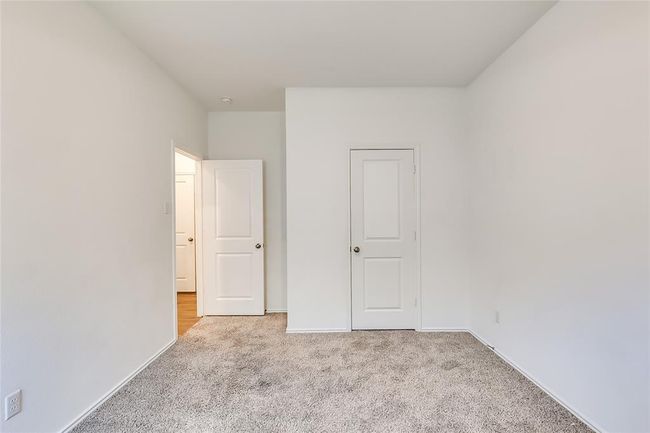 Unfurnished bedroom with carpet and baseboards | Image 23