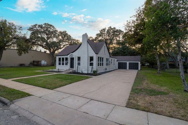 A long, double-wide driveway leads to the attached two-car garage, providing plenty of space for parking and easy access to the home. | Image 41