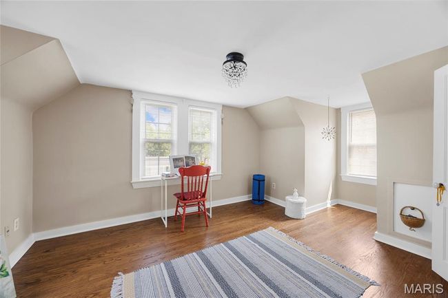 Bonus room featuring vaulted ceiling and wood finished floors | Image 23