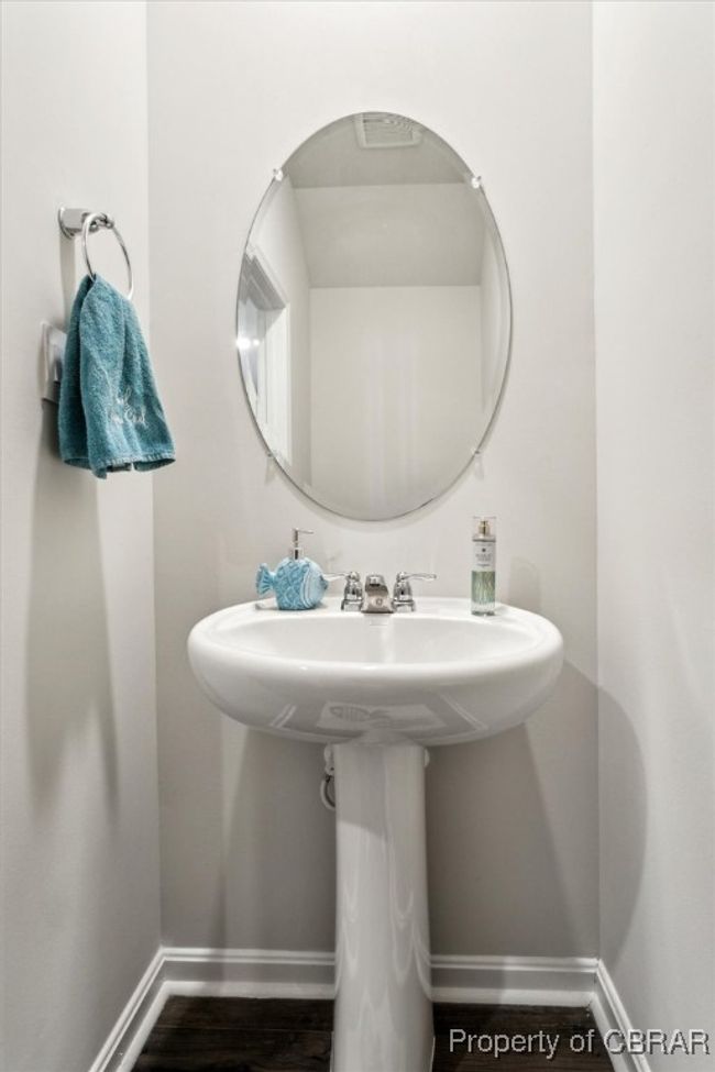 Bathroom featuring baseboards and wood finished floors | Image 13
